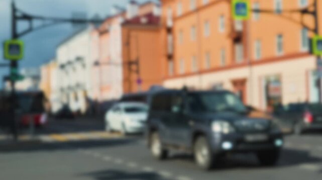 Cars move through a busy intersection while a bus approaches from the opposite direction. Defocus effect, blur