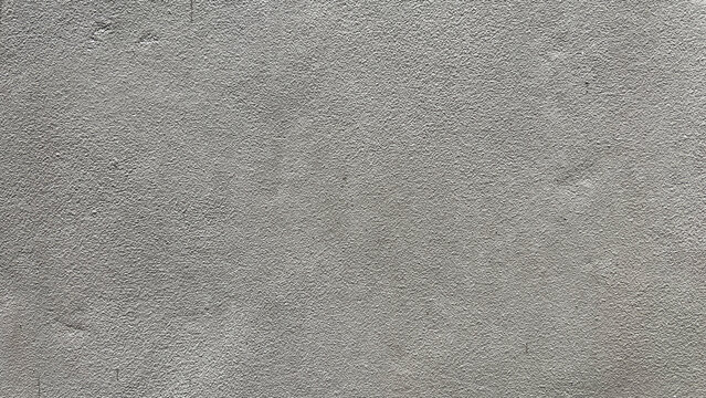 The photo reveals the rough surface of a painted, patterned plaster wall that has been prepared to look like bare concrete.