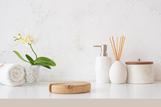 Wooden podium for bath and spa products on bathroom abstract plaster texture wall background