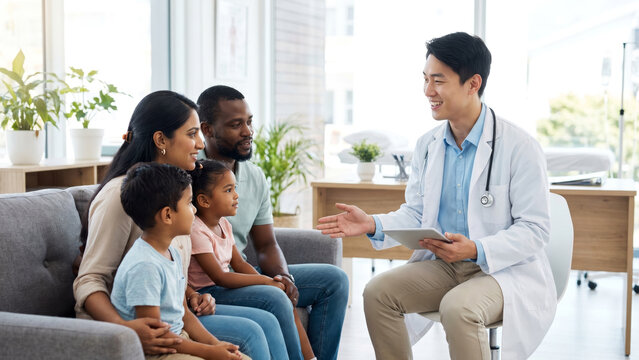 Asian man doctor stethoscope tablet explain Indian mother Black African American father interracial mixed race two children modern bright clinic smiling friendly compassionate pediatric patient care