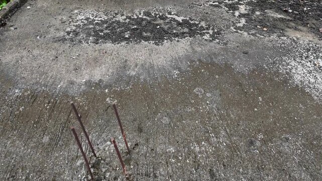 an outdoor concrete surface that appears aged and weathered.