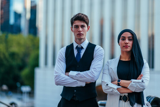 Diverse business professionals standing with arms crossed