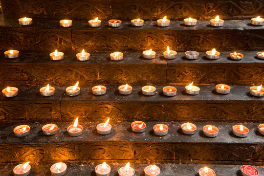 candles on row are illuminate for pray the god. The light to shine so brightly when the darkness must be happen concept