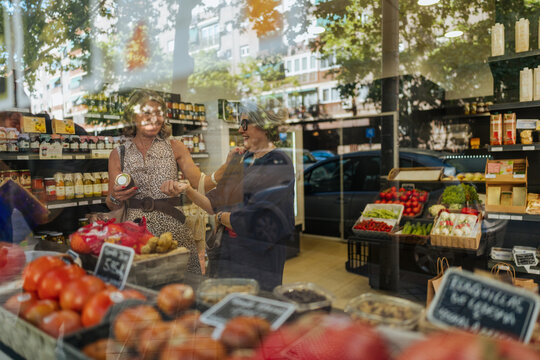 Women shopping for organic food products at supermarket