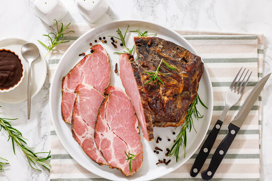 Smoked and baked pork collar on a plate