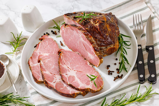 Rauch-Schweinshals pork meat is served on a plate