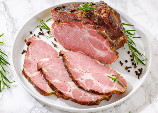 Rauch-Schweinshals pork meat on a white plate