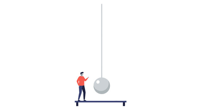 Person examining large pendulum ball physics experiment setup.