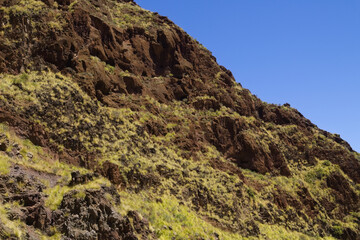 Fototapeta premium Views along the scenic hiking trail ascending from San Pedro,descending from the high threshing ground Era de Berbique toward the coastal village of Puerto de las Nieves in northwest Gran Canaria, Can