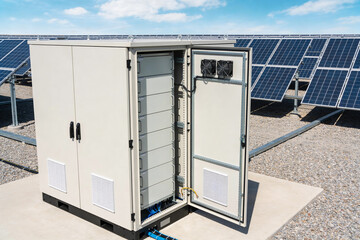 Outdoor solar power inverter cabinet with battery storage and solar panels © Snide12