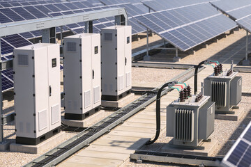Solar power station equipment with inverters and transformers on a rooftop © Snide12