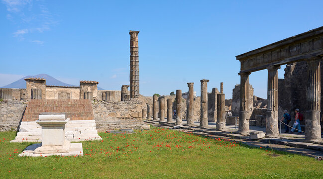 Historic ruins of the ancient city of Pompeii with Mount Vesuvius rising in the background. Pompei, Campania, Italy