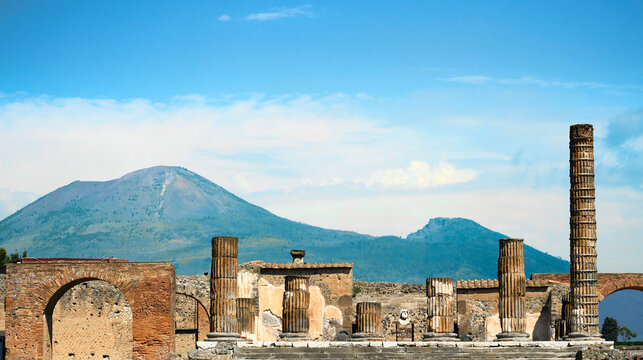 Historic ruins of the ancient city of Pompeii with Mount Vesuvius rising in the background. Pompei, Campania, Italy