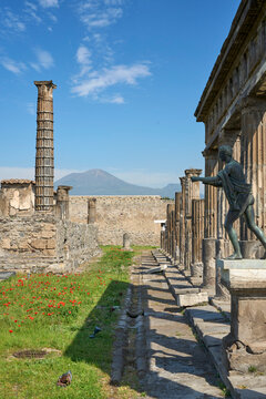 Historic ruins of the ancient city of Pompeii with Mount Vesuvius rising in the background. Pompei, Campania, Italy