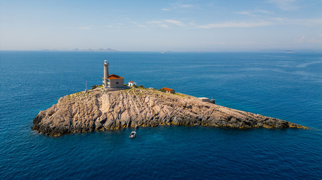 Aerial view of Blitvenica Lighthouse on a rocky islet surrounded by the deep blue Adriatic Sea under a clear sky Zirje, Sibensko-kninska zupa, Croatia.