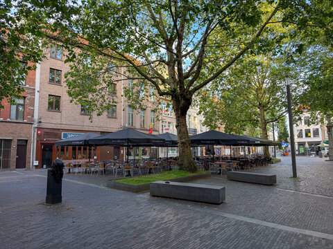 Empty Outdoor Cafe Terrace with Black Umbrellas on Cobblestone Square, Antwerpen, Belgi&euml;