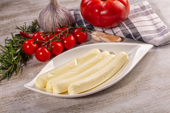 Fresh string cheese on white plate with tomatoes garlic and rosemary