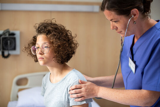 Doctor examining patient in hospital