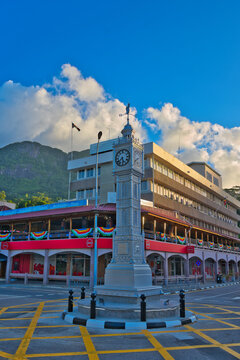 The newly restored Victoria Clock Tower stands proudly in the town centre of Mah&eacute;, Seychelles. This iconic historical landmark is adorned with national flags against a beautiful tropical backdrop