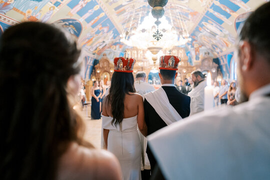 Traditional Orthodox wedding ceremony with crowns in ornate church