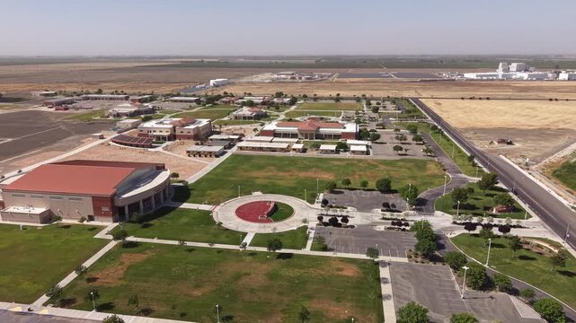 Sweeping aerial perspective capturing the modern campus of West Hills College Lemoore, featuring its distinct architecture, green lawns, and surrounding agricultural landscape of Central Valley