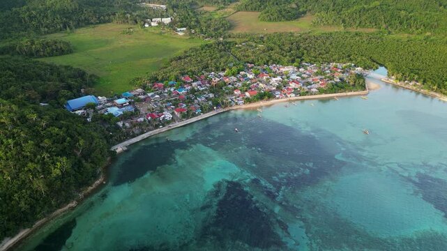 Stunning aerial footage captures Magnesia Del Norte&rsquo;s vibrant coastal village, turquoise waters, lush greenery, and tranquil island scenery.