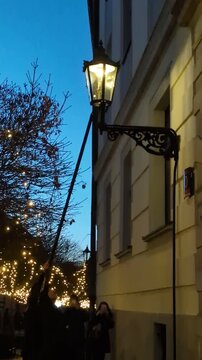 Traditional lamplighter lighting a vintage gas street lamp at dusk on the historical cobblestone streets of Ostrow Tumski in Wroclaw, Poland, atmospheric culture and travel concept video clip