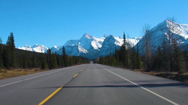 Driving POV on Icefields Parkway Toward Snow Capped Canadian Rockies