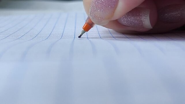 the hand writes with a pen. The concept of signing an agreement, a contract. Studying at a university, school