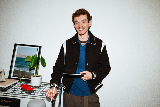 A tablet scene with a young man using mobile apps indoors.
