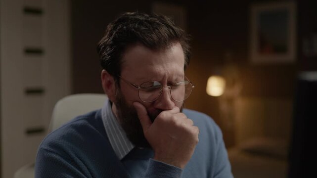 Man at computer yawning from fatigue or boredom. Close-up