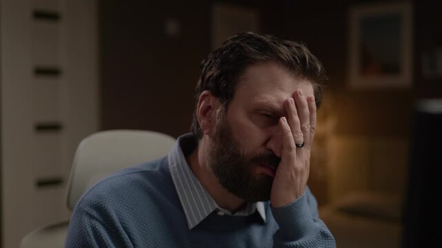 Facepalm. Frustrated man puts his hand to his face. Close-up
