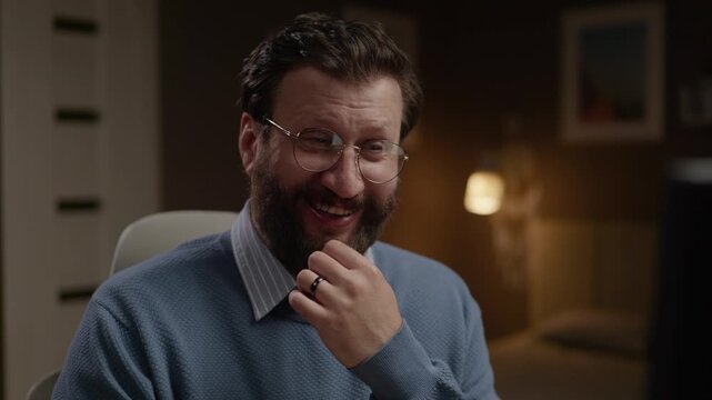 Man at computer laughing hysterically and sarcastically. Close-up