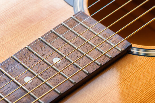 Closeup view of new strings on an acoustic guitar