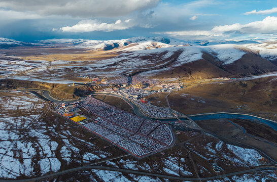 Aerial panorama of Yarchen Gar Buddhist Academy after snowfall in Garze, Tibet, China