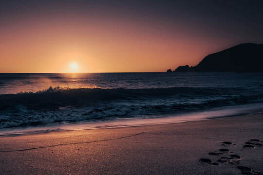 Finisterre Sunset in Galicia, Spain. Mar de Fora beach and Nave cape in Costa da Morte. This is the final step in the Camino de Santiago.