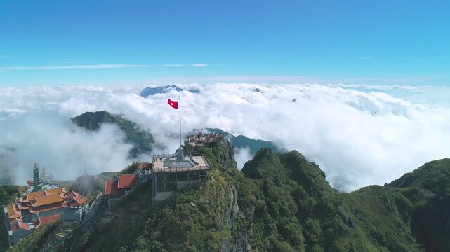 Aerial view of Fansipan Peak above sea of clouds in Sapa Vietnam