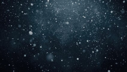 Fototapeta premium Snowflakes gently falling in a dark winter scene