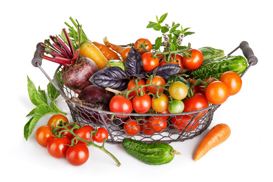 Fresh vegetables in basket. Isolated on white background