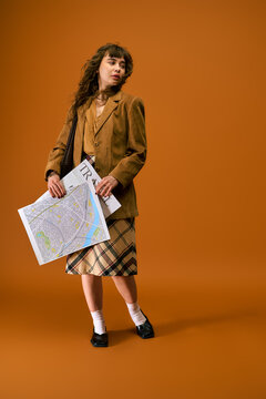 Young woman ready for summer adventure with travel map in stylish attire