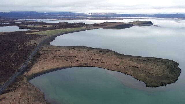 Stunning aerial footage of the surreal landscape of Lake Myvatn in Iceland, with swarms of midges flying over the volcanic terrain