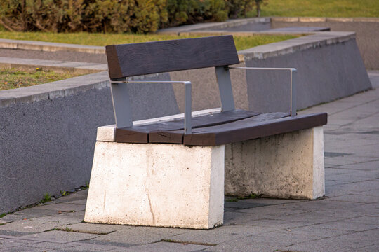 Retro empty wood stone bench outside in park pavement