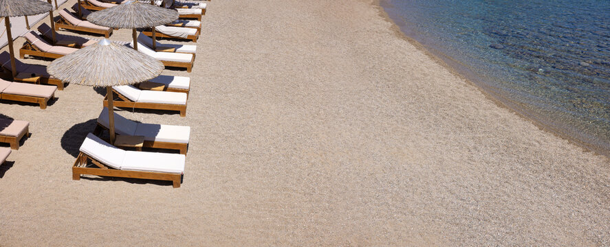 Empty Sunbeds and parasols on the beach Vai in north eastern Crete island, Greece.