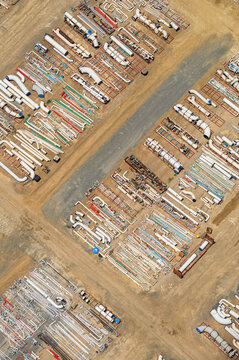 Industrial yard with pipes and organised storage rows