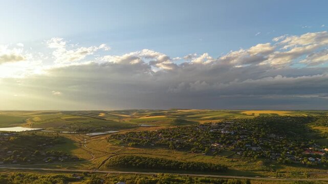 Beautiful moldovan rural landscape at sunset, scenic drone view of rolling hills and traditional village countryside