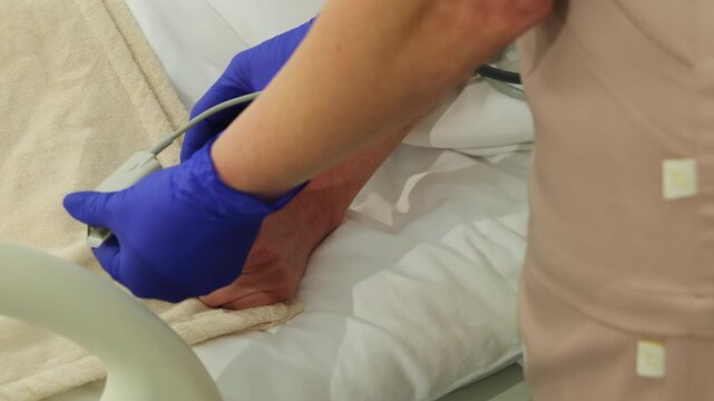 Nurse places pulse oximeter on woman finger lying on hospital bed. Medical worker steadies hand as securing sensor clip for reading