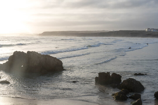 Surfers in the water in the early morning Baleal, Peniche, Portugal