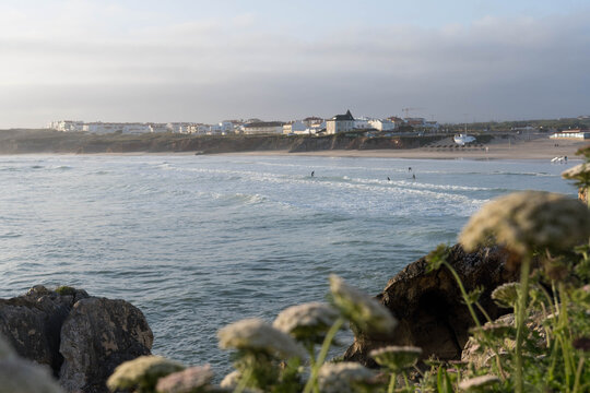 Surfers in the ocean at sunrise.Baleal, Peniche, Portugal
