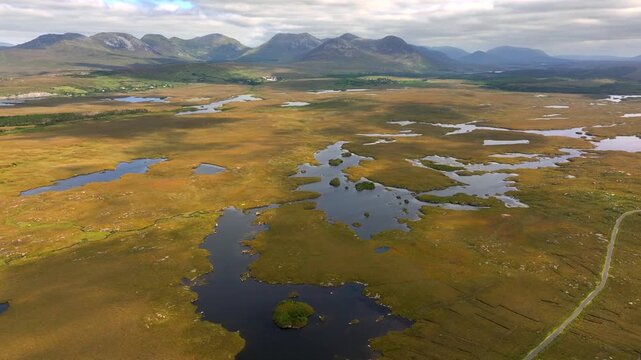 A Peat Lake in Donegal countryside, Ireland. Cinematic aerial Shot of a Roundstone Bog, a vast wet bogland. 
