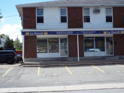 Gatineau,Quebec, Canada &ndash; May 14, 2026: A brick building houses the "La Nawab" restaurant, offering breakfast, lunch, and dinner with available dining and takeout at 1 Rue Cholette.